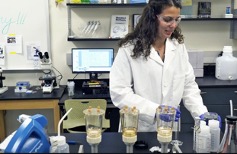 Student working with chemicals in biology lab.