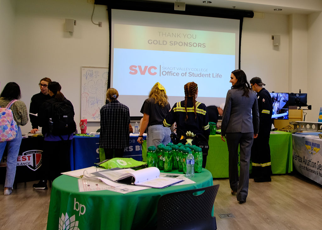 Event sponsors speaking with students