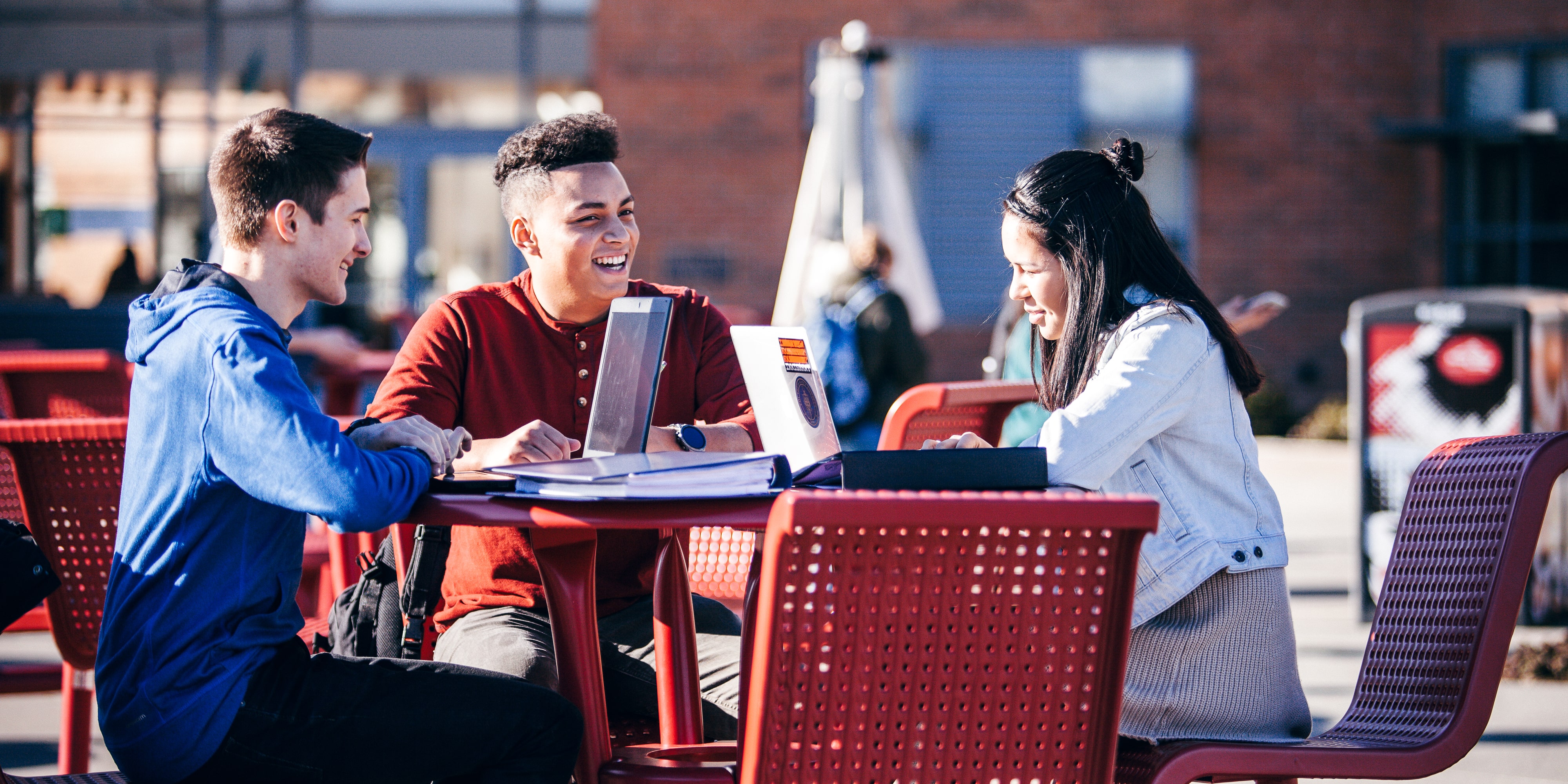 Students on Campus sitting outside 